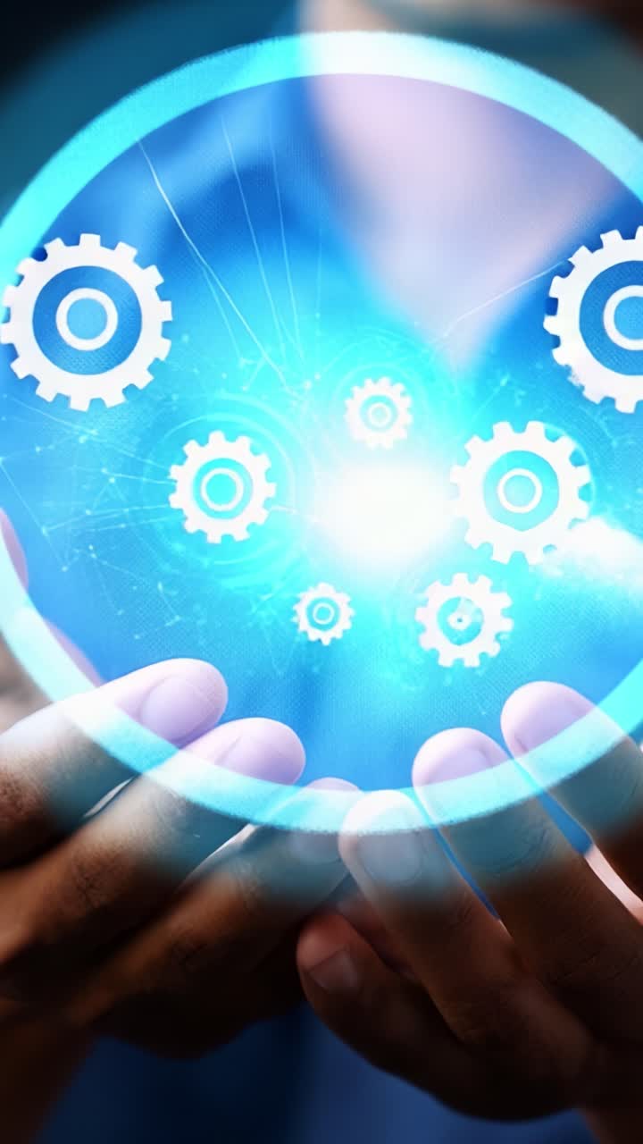 A person holds a glowing holographic display featuring rotating gears, symbolizing technology, innovation, and the interconnectedness of mechanical systems in modern industry