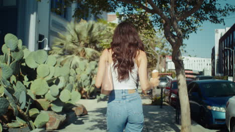 unknown woman walking street holding ice cream. asian brunette enjoy dessert.