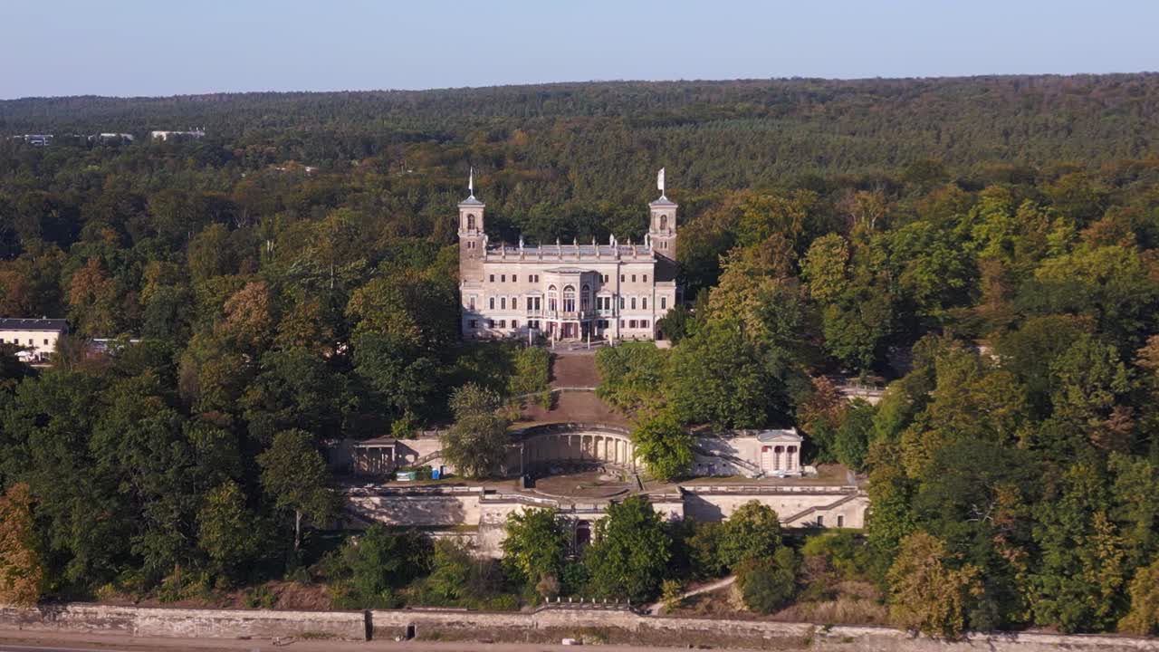 Aerial view of a grand castle surrounded by forest