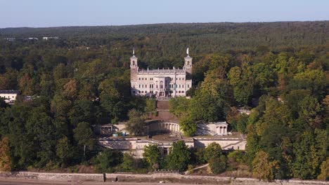 aerial view of a grand castle surrounded by forest