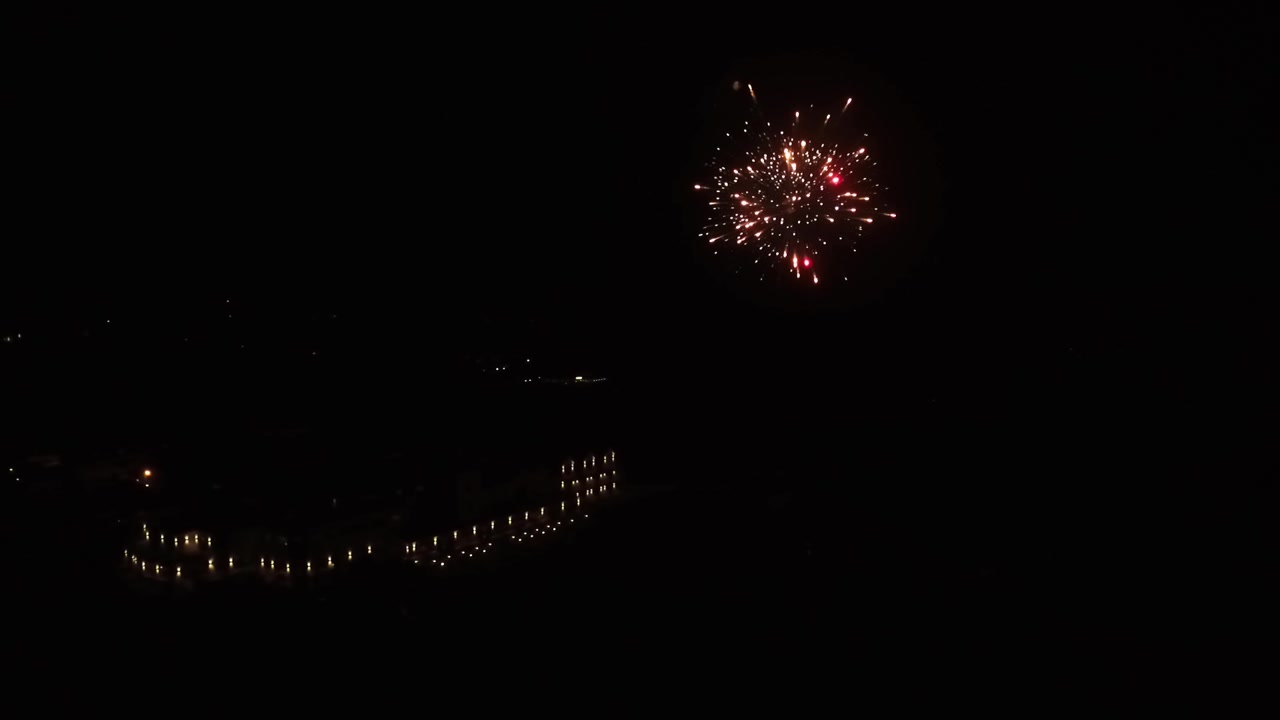 Spettacolo di fuochi d'artificio di fronte a un grande hotel.