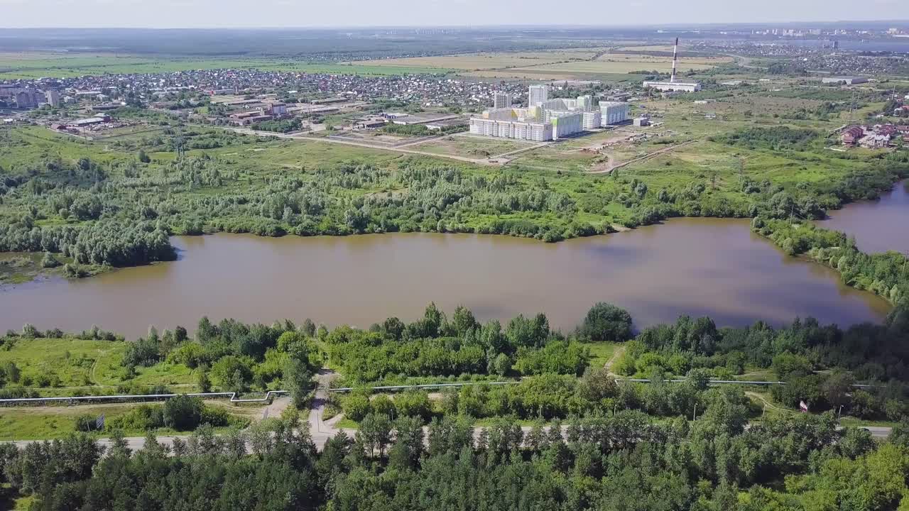 Aerial View of a City with a Lake and Forest