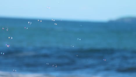 ocean waves gently crash against the shore under clear skies at charlesworth bay beach, coffs harbour, australia