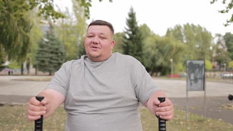 a man with a big belly is doing cardio in the park he is losing weight an overweight young man runs a man with a big belly is doing cardio in the park he is losing weight an overweight young man runs down the street the problem of obesity