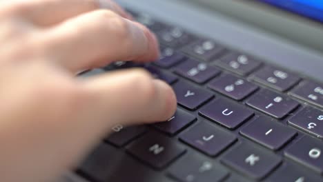 a close-up macro shot of hands trying to find placement before beginning to type on a computer laptop keyboard