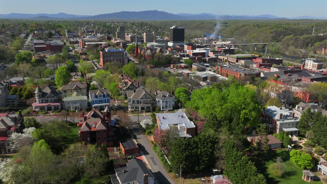 Spring hyperlapse in American city. Aerial drone time lapse featuring historic houses overlooking Lynchburg, Virginia with blossoming trees.