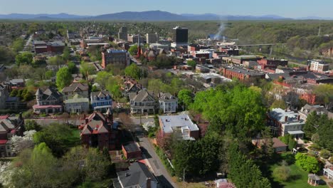 spring hyperlapse in american city. aerial drone time lapse featuring historic houses overlooking lynchburg, virginia with blossoming trees.
