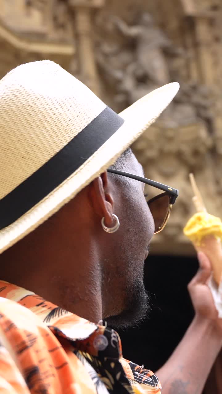 Man eating ice cream with sunglasses and hat