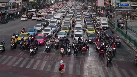 pedestrians crossing a crowded city intersection