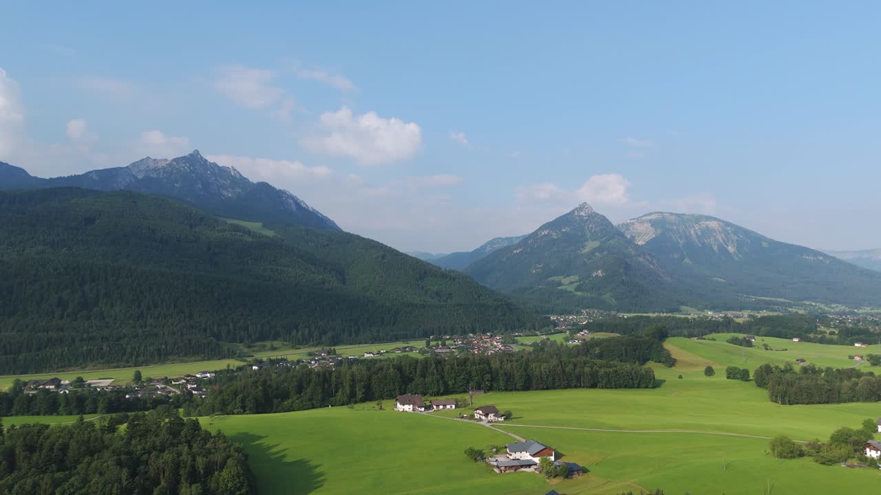 Alpine valley between Salzburg and Upper Austria with vivid green pastures in summer light