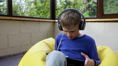 kid sitting on hassock