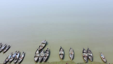 numerous boats are moored on the river