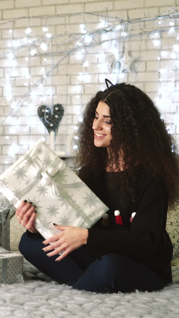 Woman with presents. Christmas woman with happy face and presents at New Year Vertical video
