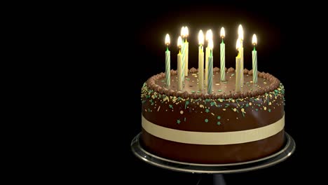 rotating chocolate cake with candles isolated on black background