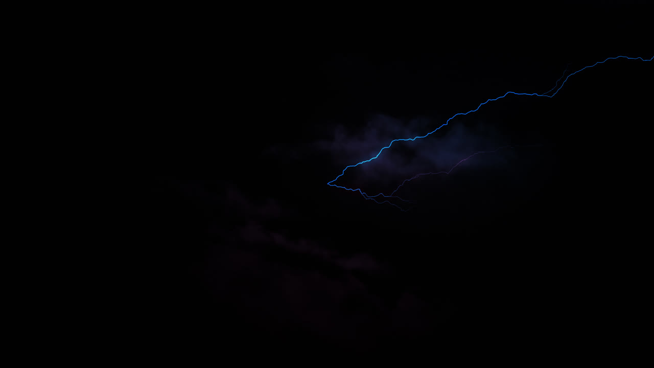Red and blue lightning bolts of electrical current flashing across dark sky