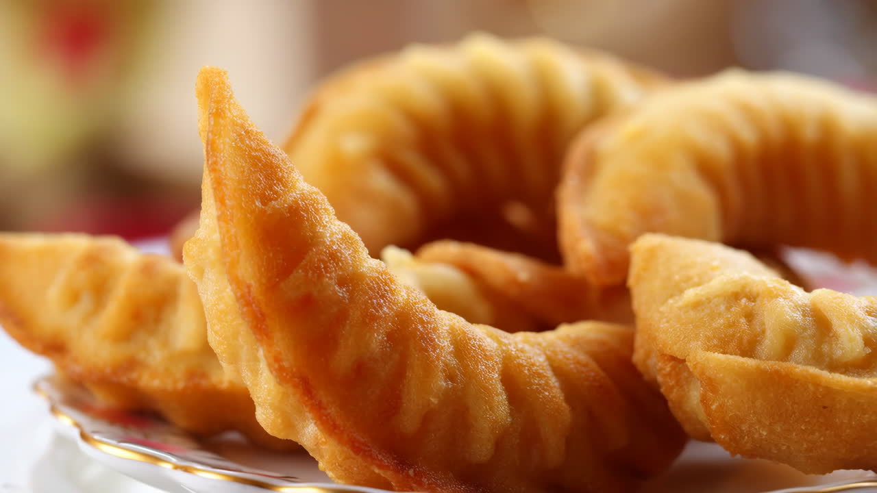 Close-up of golden-brown fried pastries on a plate