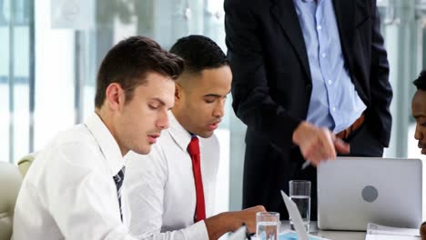 Businessman-leading-meeting-in-conference-room