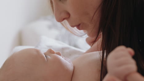 close up mother gently kissing baby enjoying loving mom playfully caring for toddler at home sharing connection with her newborn child healthy childcare