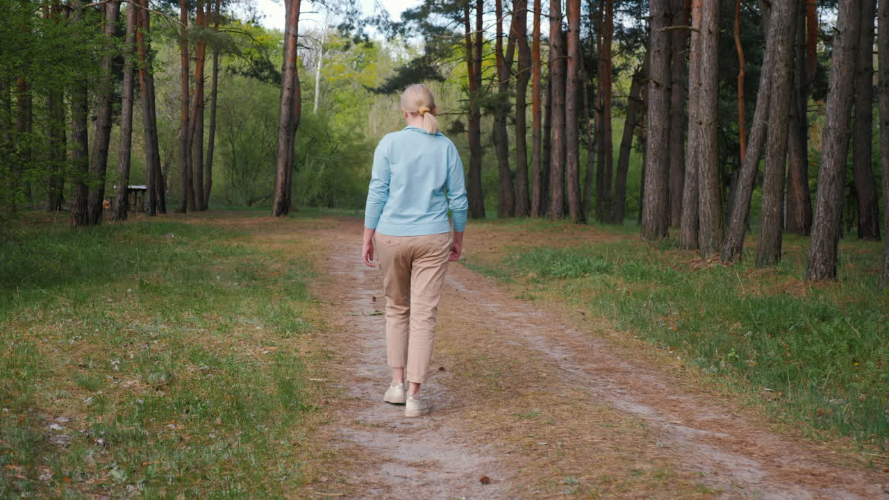 Woman Walking in a Pine Forest