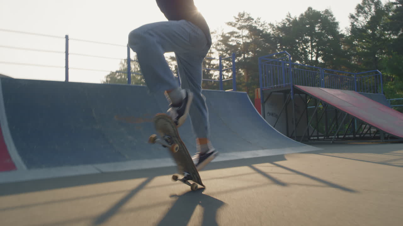 Teenager Doing Kickflip Trick in Skatepark