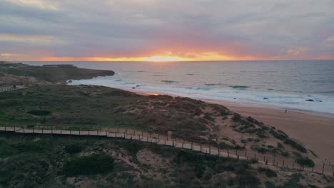 amazing golden sunset ocean coast aerial view. evening sea waves at sandy shore