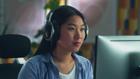 Asian Woman in Headset Working on Pc