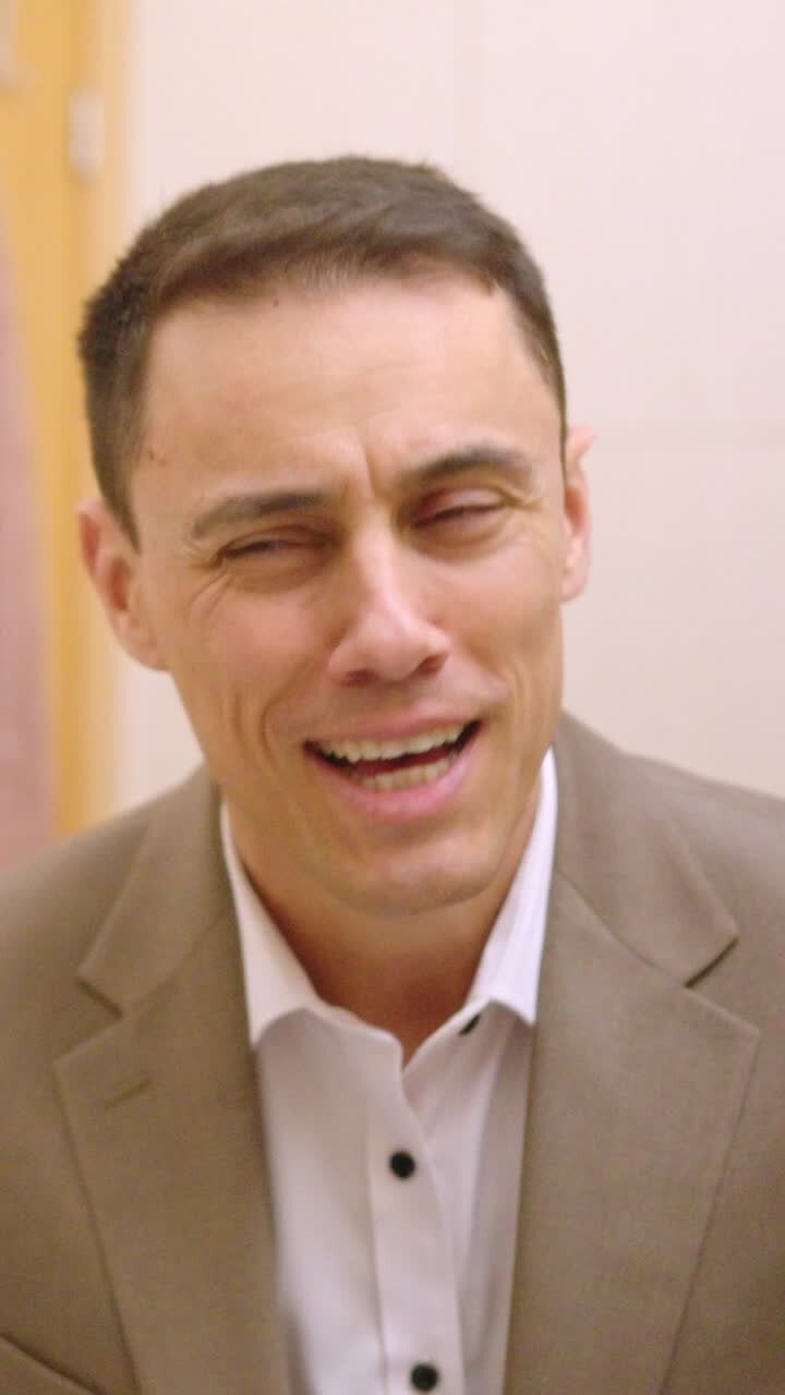 Businessman dressing up and checking himself in bathroom mirror