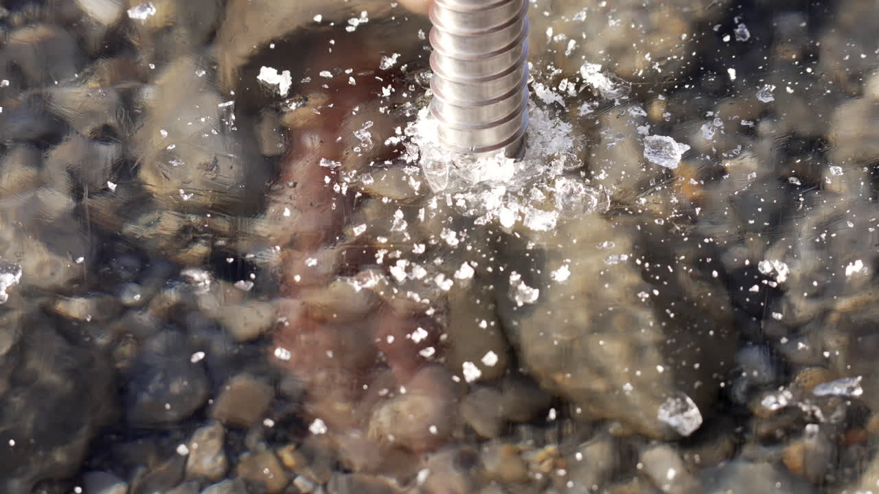 Close up of an ice screw checking thickness of ice in winter.