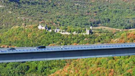 AERIAL:-Bridge-on-road-A9-with-ruins-in-the-background,-summer-in-Istria,-Croatia