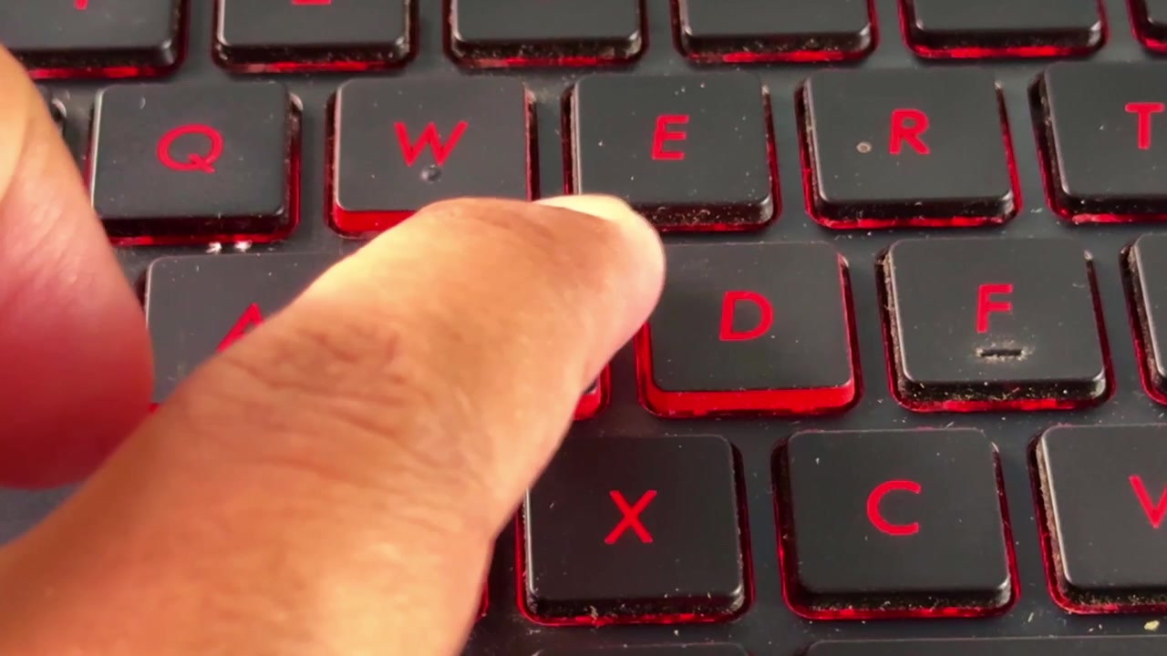 Finger tapping "S" keyboard on modern laptop, highlighting digital workflow, online activity, and tech lifestyle.