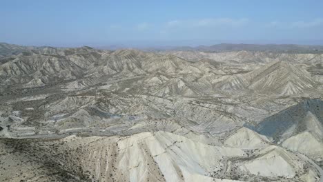 drone view of rough rocky mountains with dry river in daylight