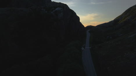 evening sunset on road through mountains, dønna, nordland county, norway - aerial drone shot
