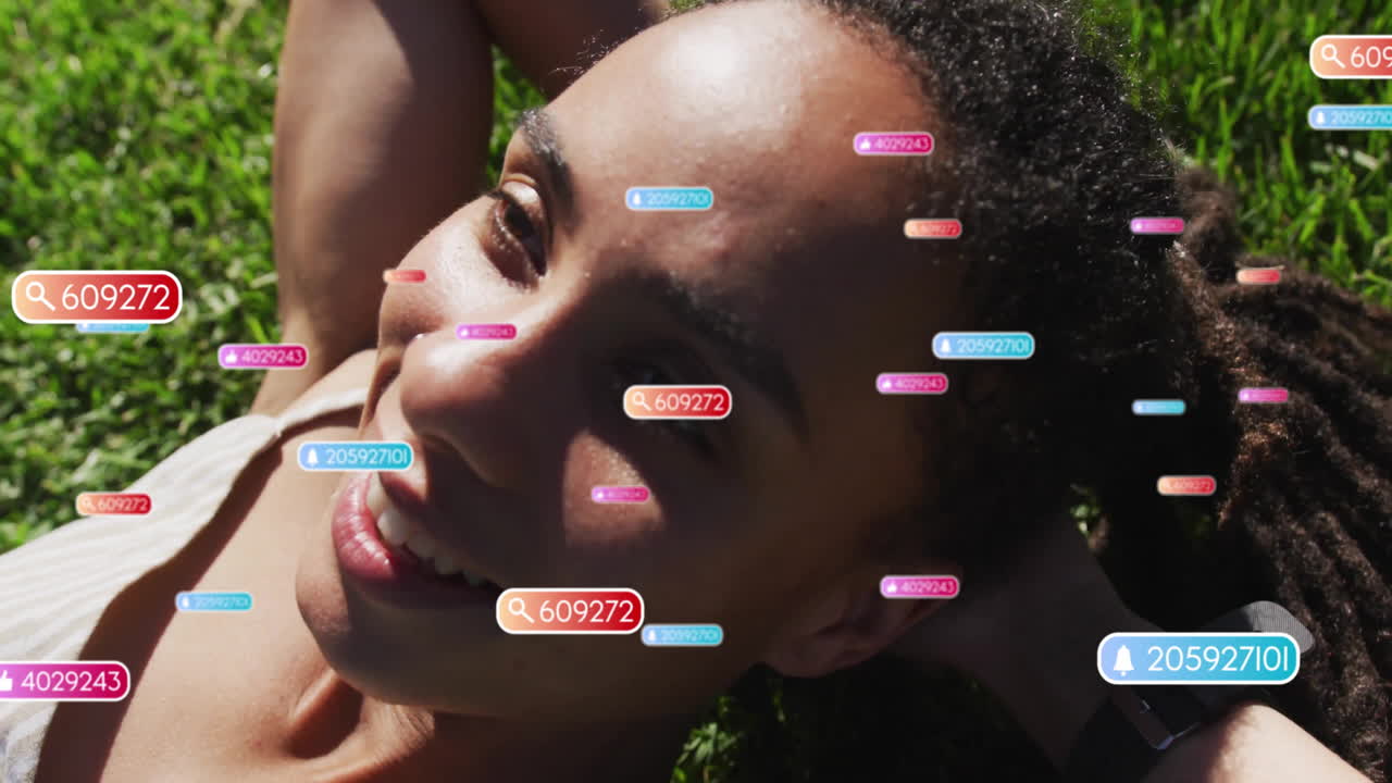 Lying on grass, person with colorful data tags overlaying, creating animation