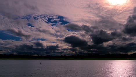 time lapse of a dramatic sky at dusk, with normal speed for the lake