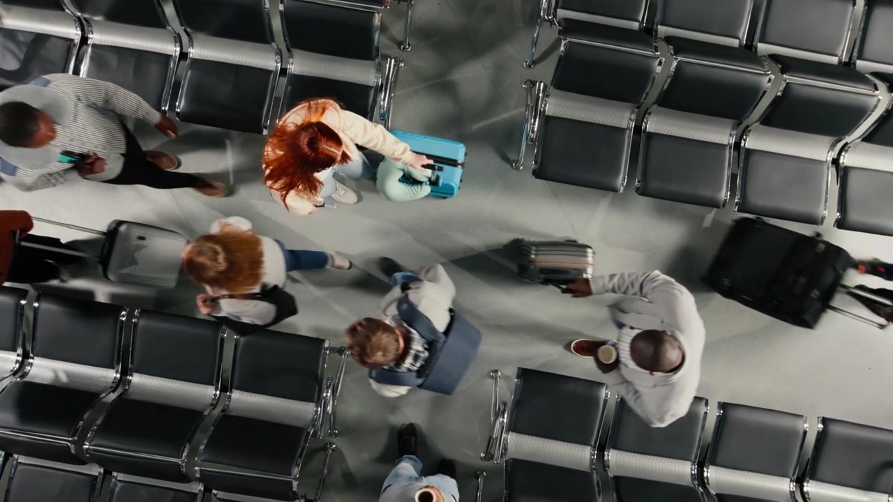 Walking, rows of empty seats and travelers in airport terminal