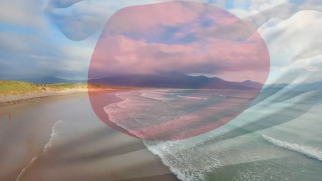 Digital-composition-of-japan-flag-waving-against-aerial-view-of-waves-in-the-sea