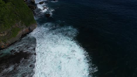 Ocean-waves-crashing-onto-cliffs-in-the-South-of-Bali,-Indonesia