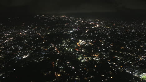 wide aerial hyperlapse of the city of freetown, sierra leone at night with traffic.