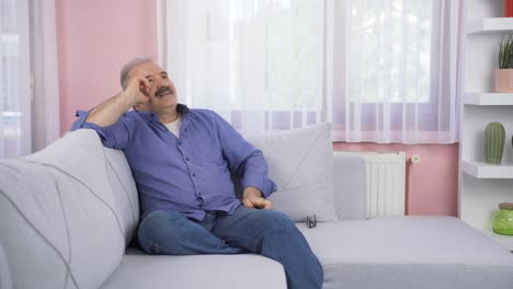 Pensive-old-man-is-watching-outside.