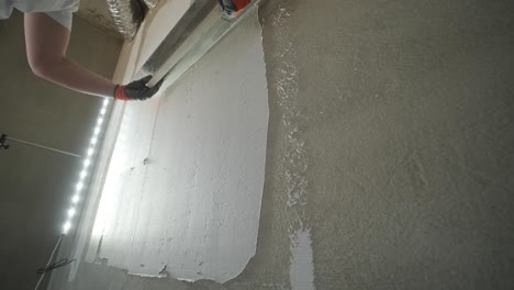 applying plaster to a wall with a finishing trowel, a skilled task in the process of wall smoothing for painting or wallpapering in construction and renovation