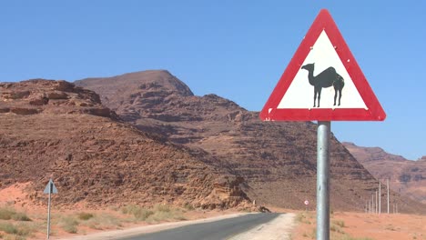 a road sign indicates camels are crossing in the saudi desert of wadi rum jordan