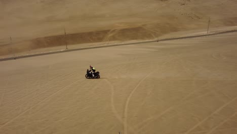 a motorcycle riding in desert dunes