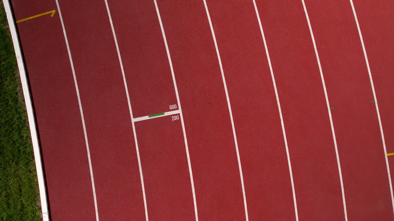 Two Female Athletes Running on a Track