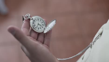 reloj de bolsillo vintage en la mano, que simboliza el tiempo y la tradición