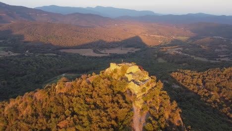 drone footage aerial view of a castle ruins on top of a mountain in catalonia spain