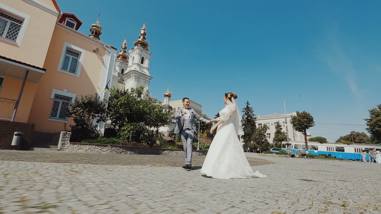 Just Married. Couple walking down the street on Wedding. Sunny Day.