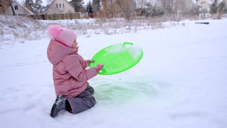 toddler girl playing outdoors , winter time