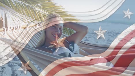 Multiple-stars-on-blue-stripes-against-portrait-of-caucasian-woman-lying-on-hammock-at-the-beach