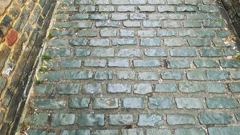 footsteps on a narrow cobblestone alley