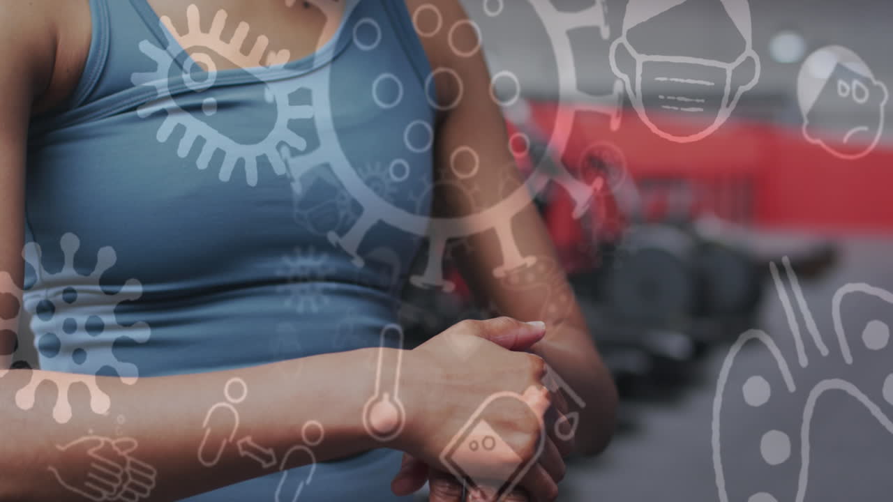 animación de iconos de covid-19 flotando sobre una mujer caucásica limpiando las manos haciendo ejercicio